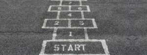 A hopscotch drawn on the floor with chalk and the beginning marked with a big Start square.
