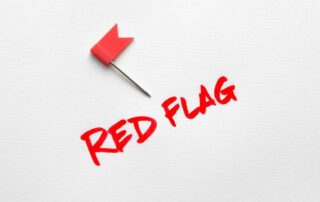 A Red Flag on a white background and letters that spell the words "red Flag".