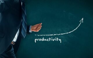 A board with the word "productivity" written on it and an arrow going upwards. On the left side of the board a man in a suite running.