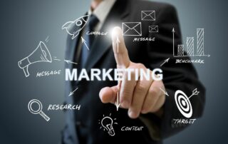 Male pointing at the word "marketing" and it's components around.